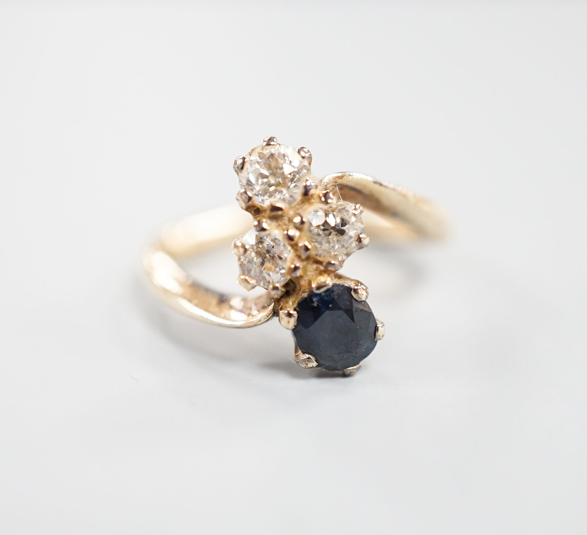 A yellow metal, sapphire an diamond set four stone dress ring, size L, gross 3.4 grams.
